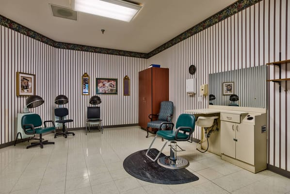 Hair salon area with styling chairs and mirrors