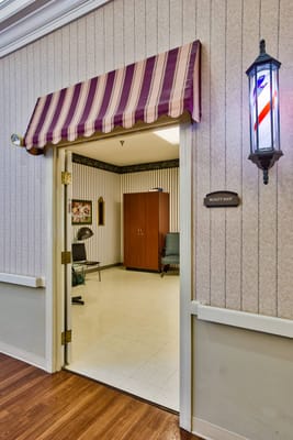 Entrance to the beauty shop with striped awning