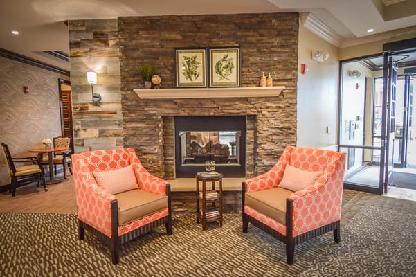 A cozy common area with seating and a fireplace