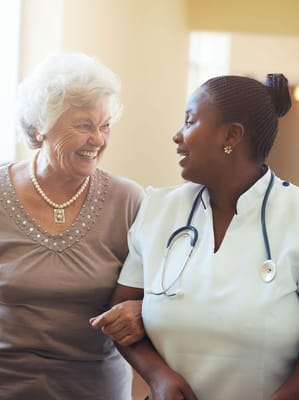 A staff member and a resident smiling together