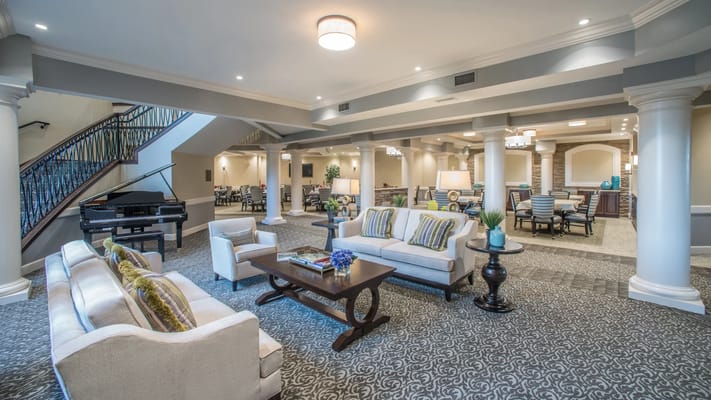 Bright common area with seating and piano
