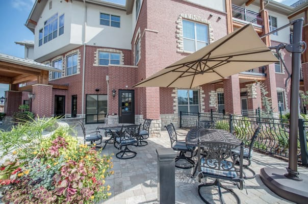 Outdoor seating area with tables and umbrellas