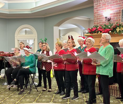 Residents singing carols in a festive common area
