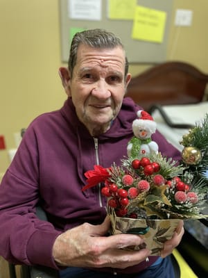 Resident holding a festive decoration during the holidays