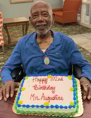 Resident celebrating 102nd birthday with cake