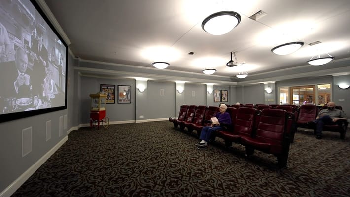 Residents enjoying a movie in a common area