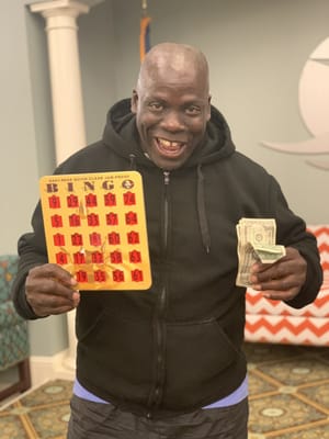 Resident celebrating a bingo win in the activity room