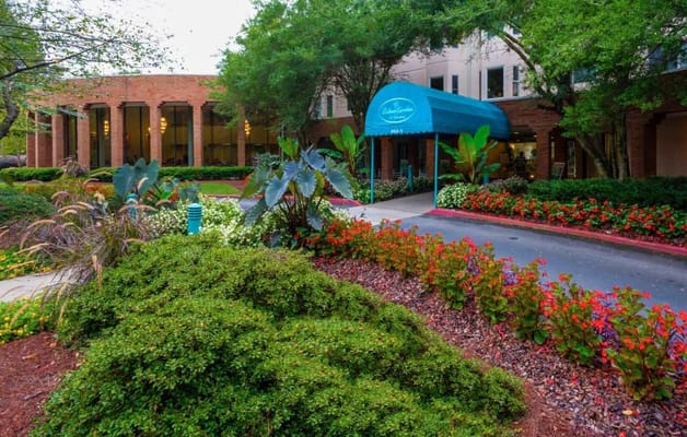 Entrance area with landscaping and awning.