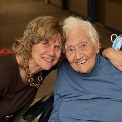 Resident and staff member sharing a joyful moment