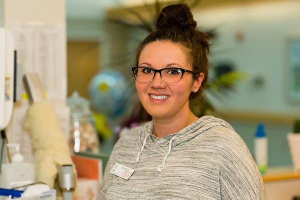 Staff member smiling in a facility setting