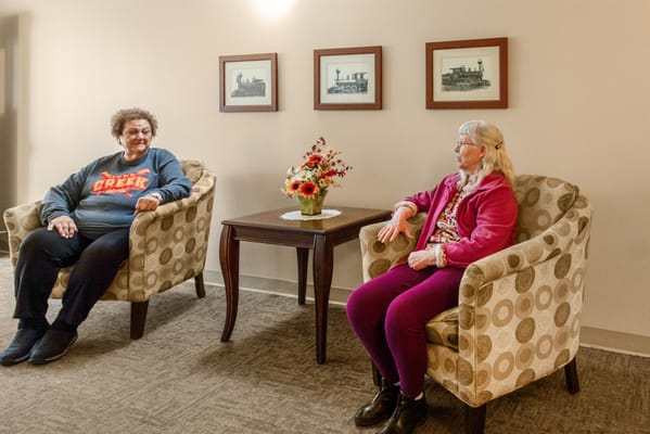 Residents enjoying conversation in a lounge area