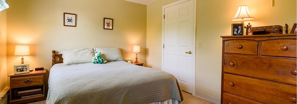 Cozy resident room with a bed and dresser