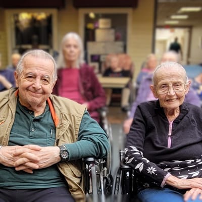 Two residents smiling in a communal area
