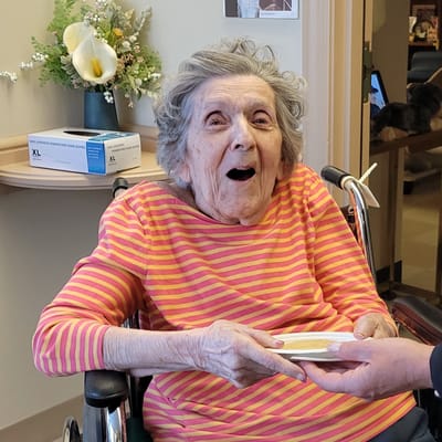 Resident smiling in a bright interior setting