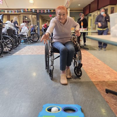 Resident playing an interactive game in a common area