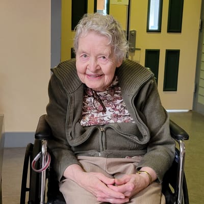 Resident in a wheelchair, smiling warmly