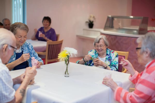 Residents enjoying dessert in the dining room