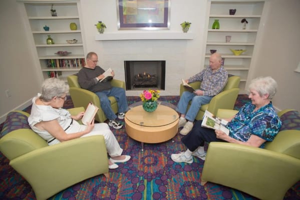 Residents enjoying quiet reading time in a cozy lounge