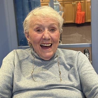 Happy resident smiling in a bright room