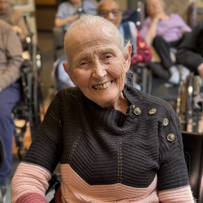 A smiling resident in a common area