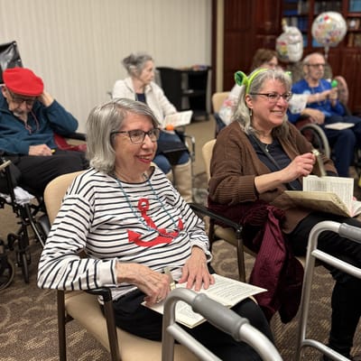 Residents engaged in an activity session reading books