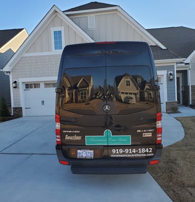 Facility transport van with logo and contact information