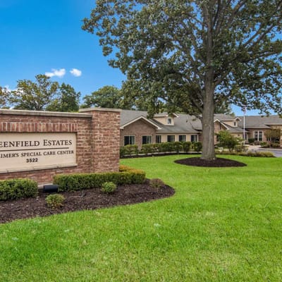 Exterior view of Greenfield Estates building with landscaping