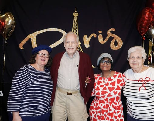Residents and staff posing together at a themed event