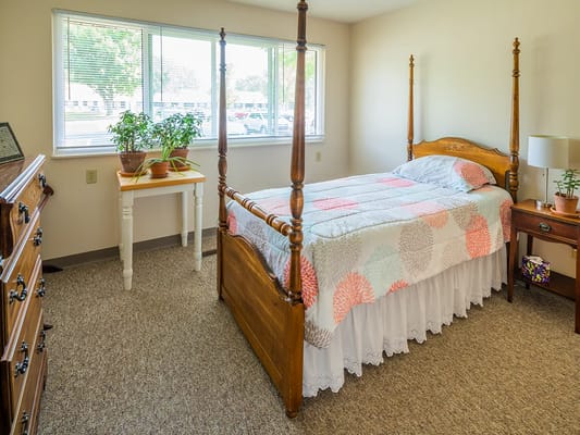 Cozy resident room with a bed and plants