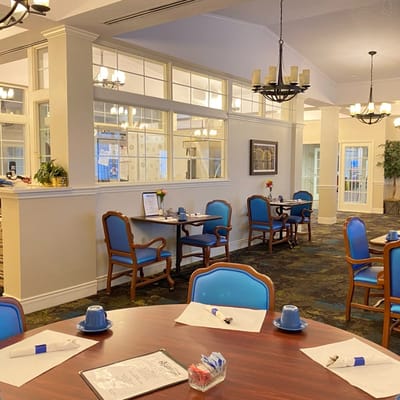 Bright dining area with blue chairs and tables