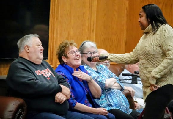Residents enjoying a lively performance in the common area