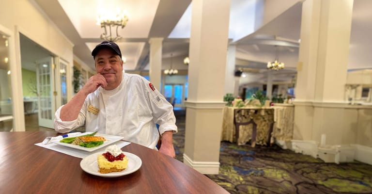 Chef presenting a meal in the dining room
