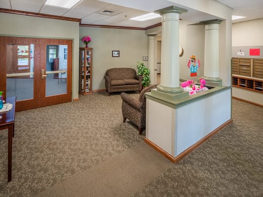 Interior view of a lobby area with seating and mailboxes