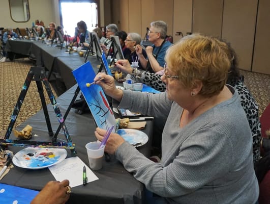 Residents participating in an art activity in a common area