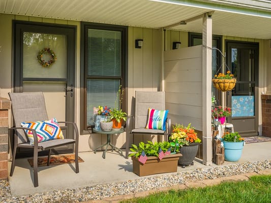 Front porch with chairs and flower pots