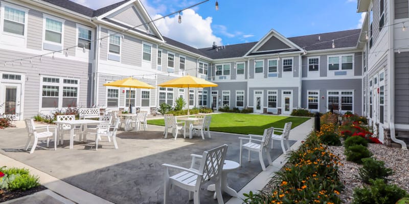 Courtyard with seating and umbrellas in a senior living community