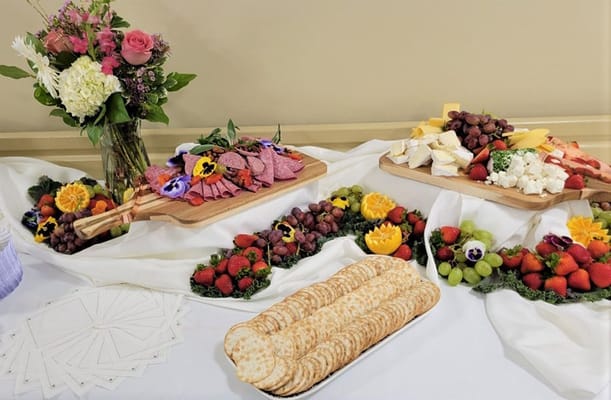 A beautifully arranged food platter with fruits and cheese
