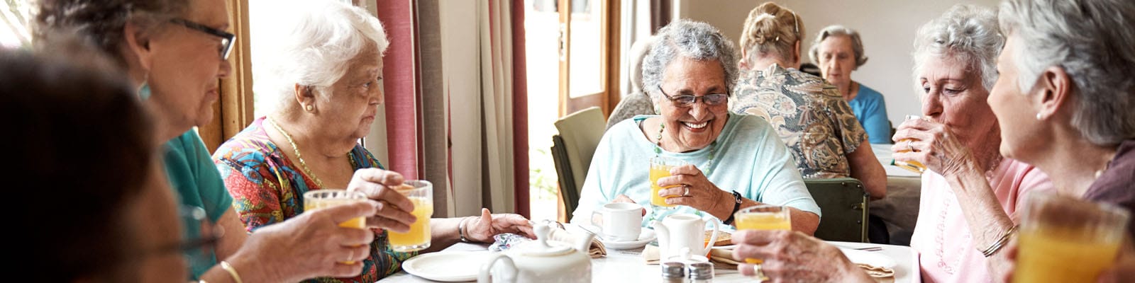 Residents enjoying a meal together in the dining room