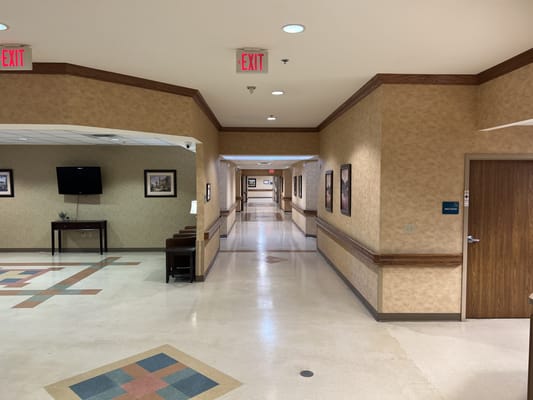 Interior hallway with decorative walls and exit signs