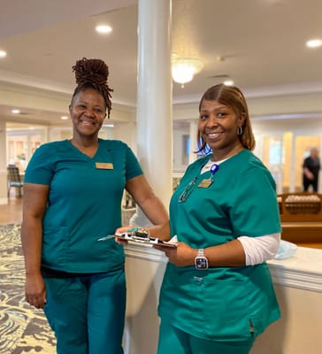 Two staff members smiling in the facility's interior