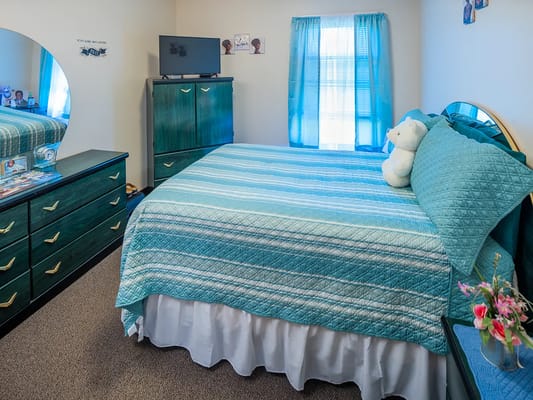 Cozy private resident room with teal decor
