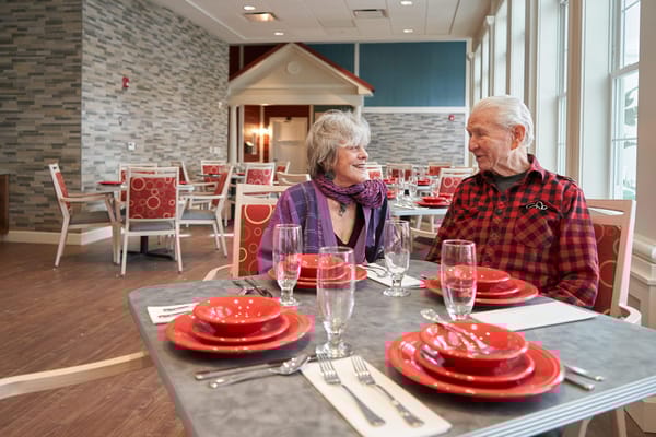 Residents enjoying a meal together in a dining room