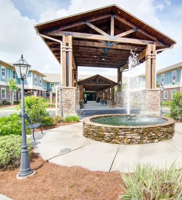 Exterior view of the facility with a fountain and covered entrance