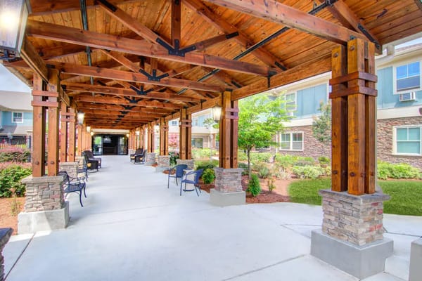 Covered entrance area with seating and landscaping