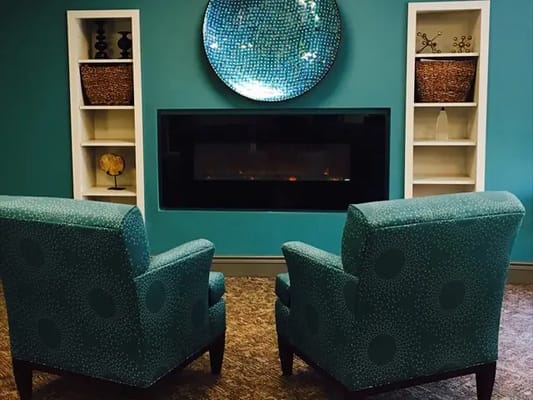 Cozy seating area with teal chairs and modern decor
