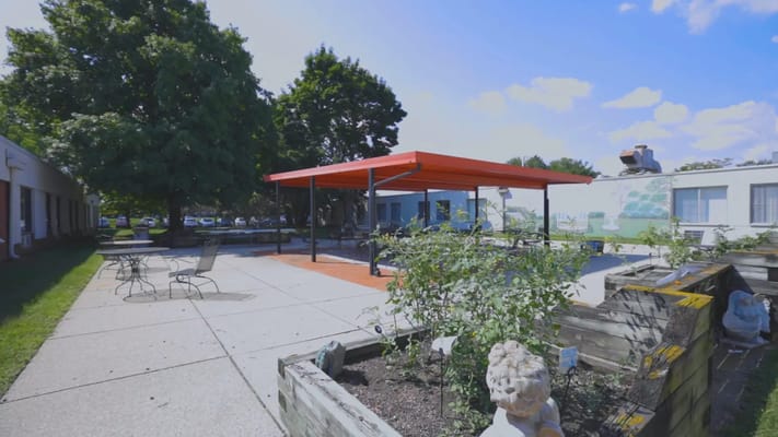 Outdoor space with shaded seating and greenery