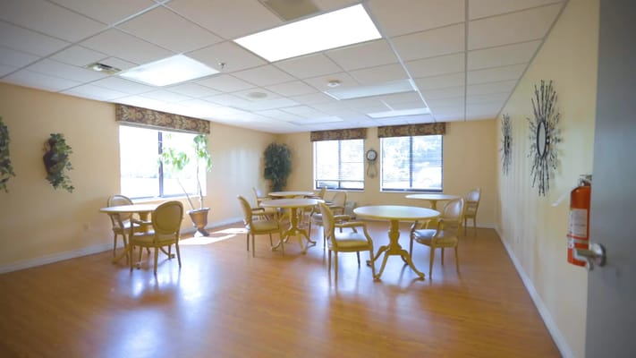 Bright common area with round tables and chairs