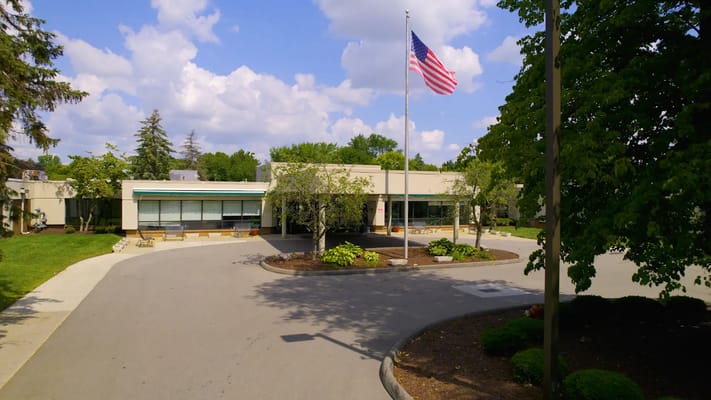 Exterior view of the Medilodge building with flag and landscaping