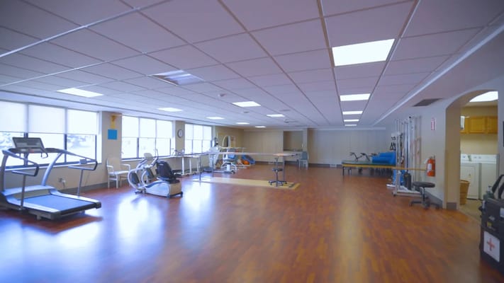 Bright and spacious therapy room with exercise equipment