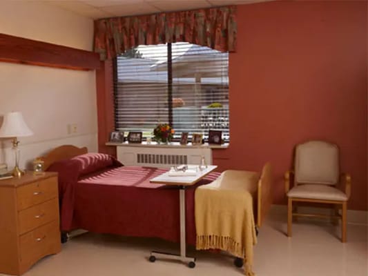 A private resident room with a bed and window